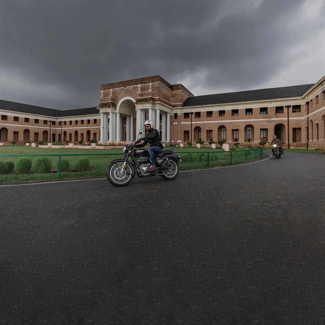 Man Riding a Royal Enfield Bullet 350 Motorcycle