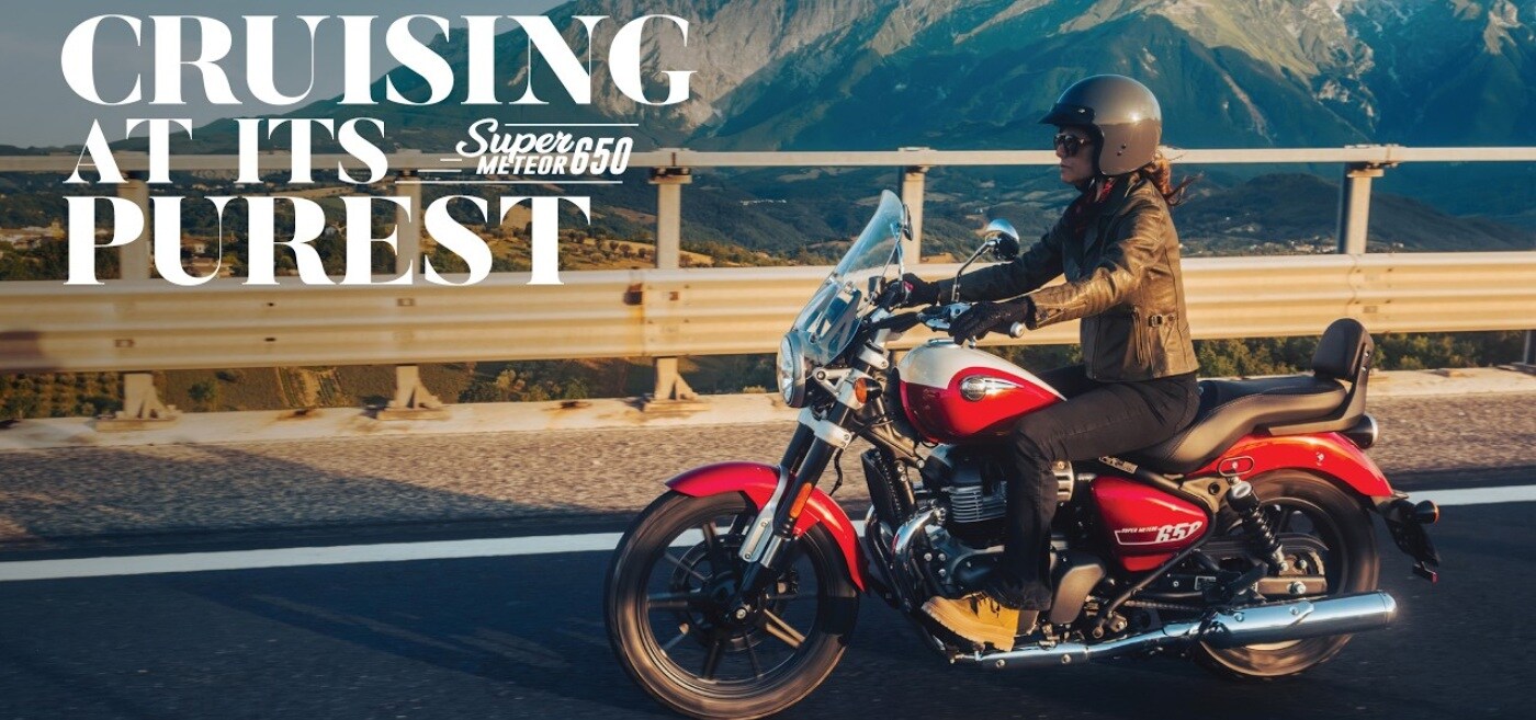 Super meteor 650 Motorcycles ride along a winding road through a desert landscape at dusk.